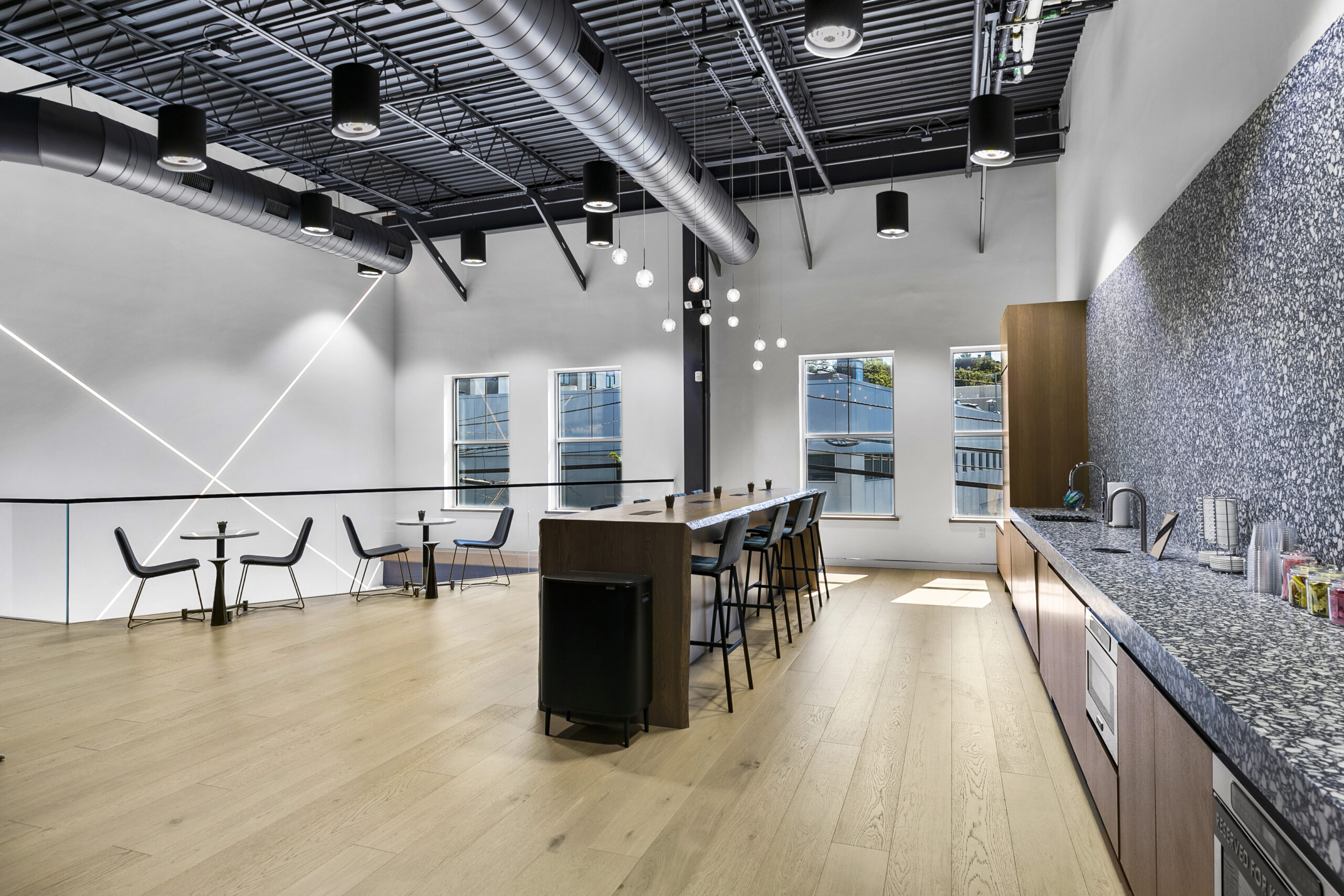 Filamento lights used for high ceiling office space, Dean Street - KABR Group, located in Englewood, New Jersey, increasing LED output, reducing glare, and increasing efficiency.