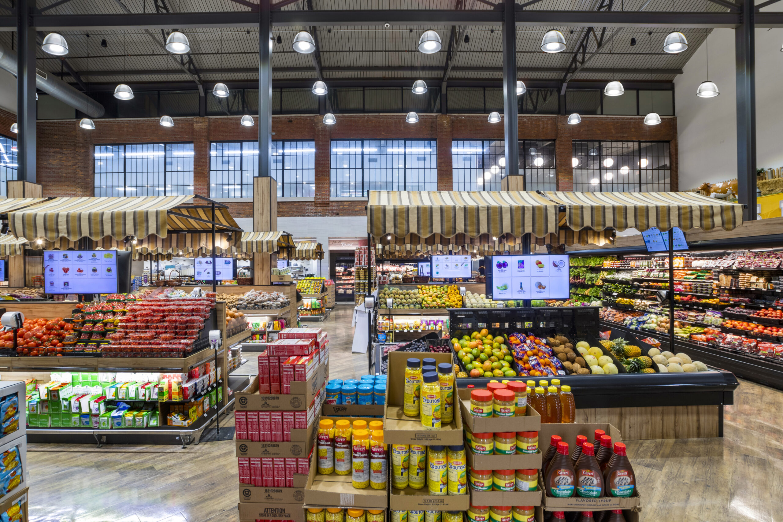 Filamento lights used for high ceiling grocery store Aisle One located in Passaic, New Jersey, increasing LED output, reducing glare, and increasing efficiency.
